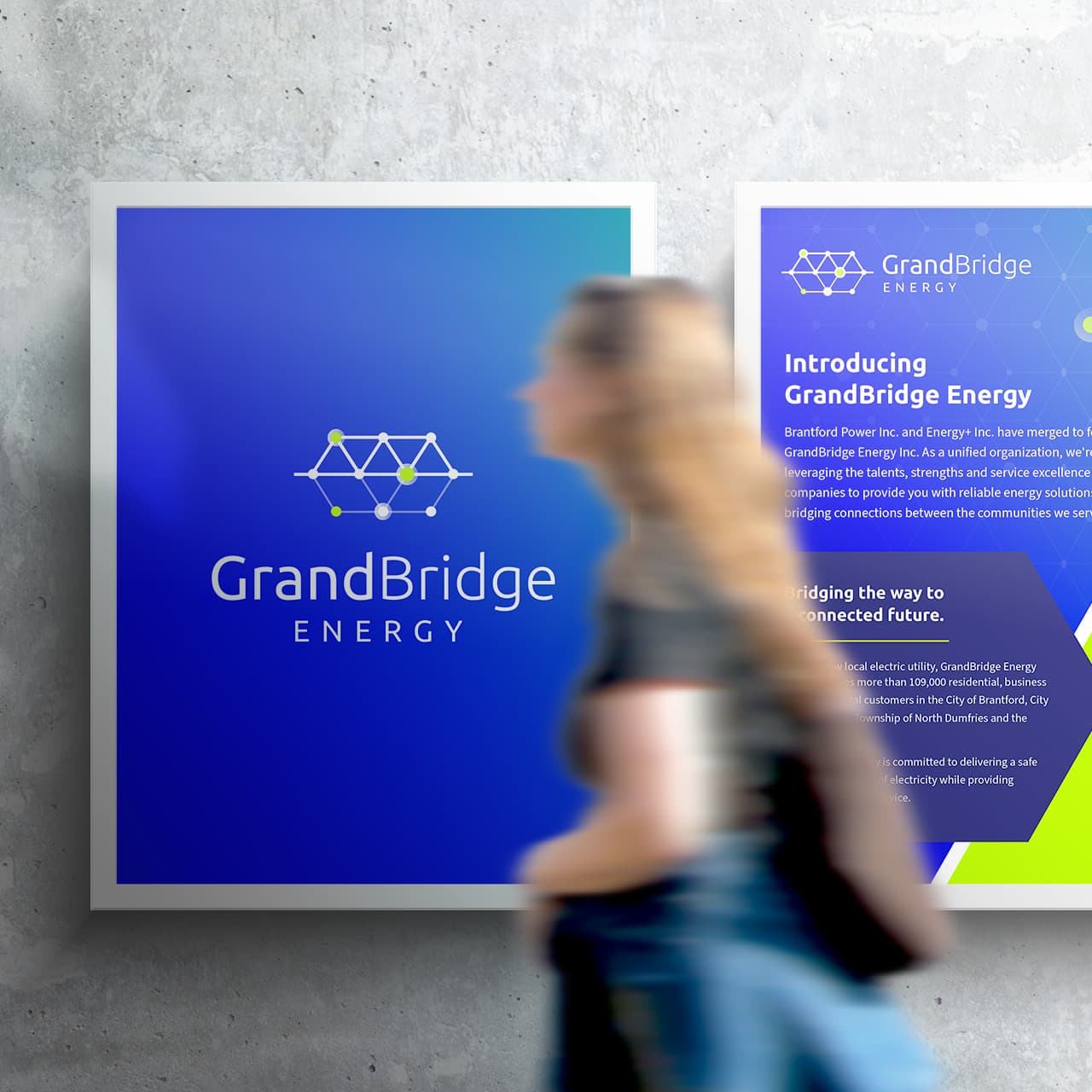 GrandBridge branded poster with a woman passing by