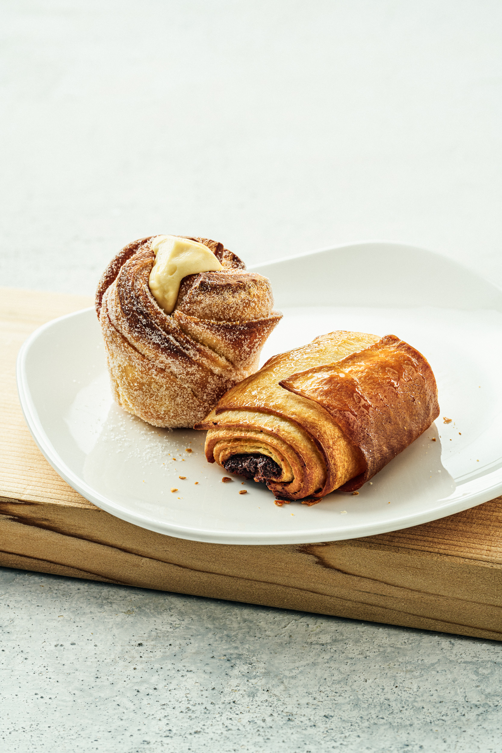 Croissant and muffin on a white plate