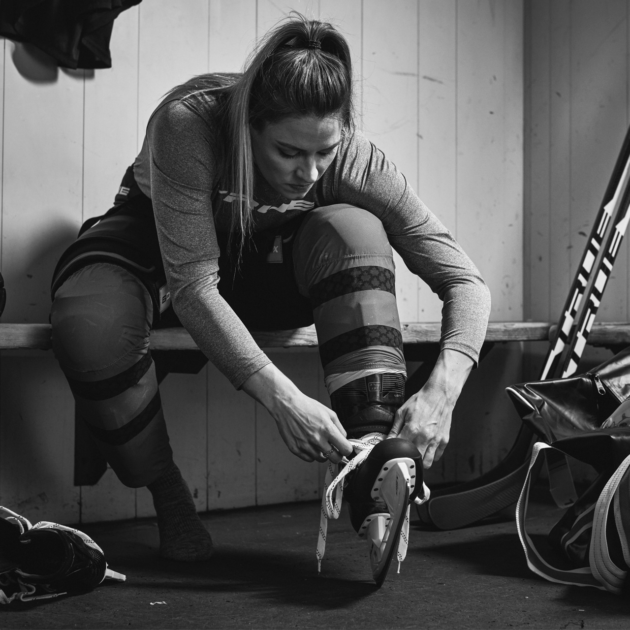 Natalie Spooner tieing skate laces in a locker room