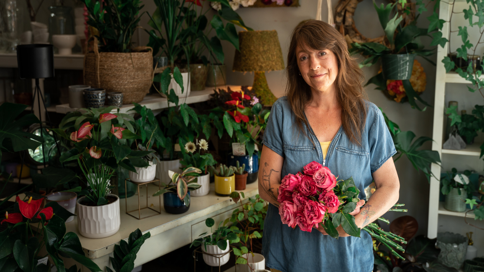 Woman holding a bouquet of flowers in a floral shop