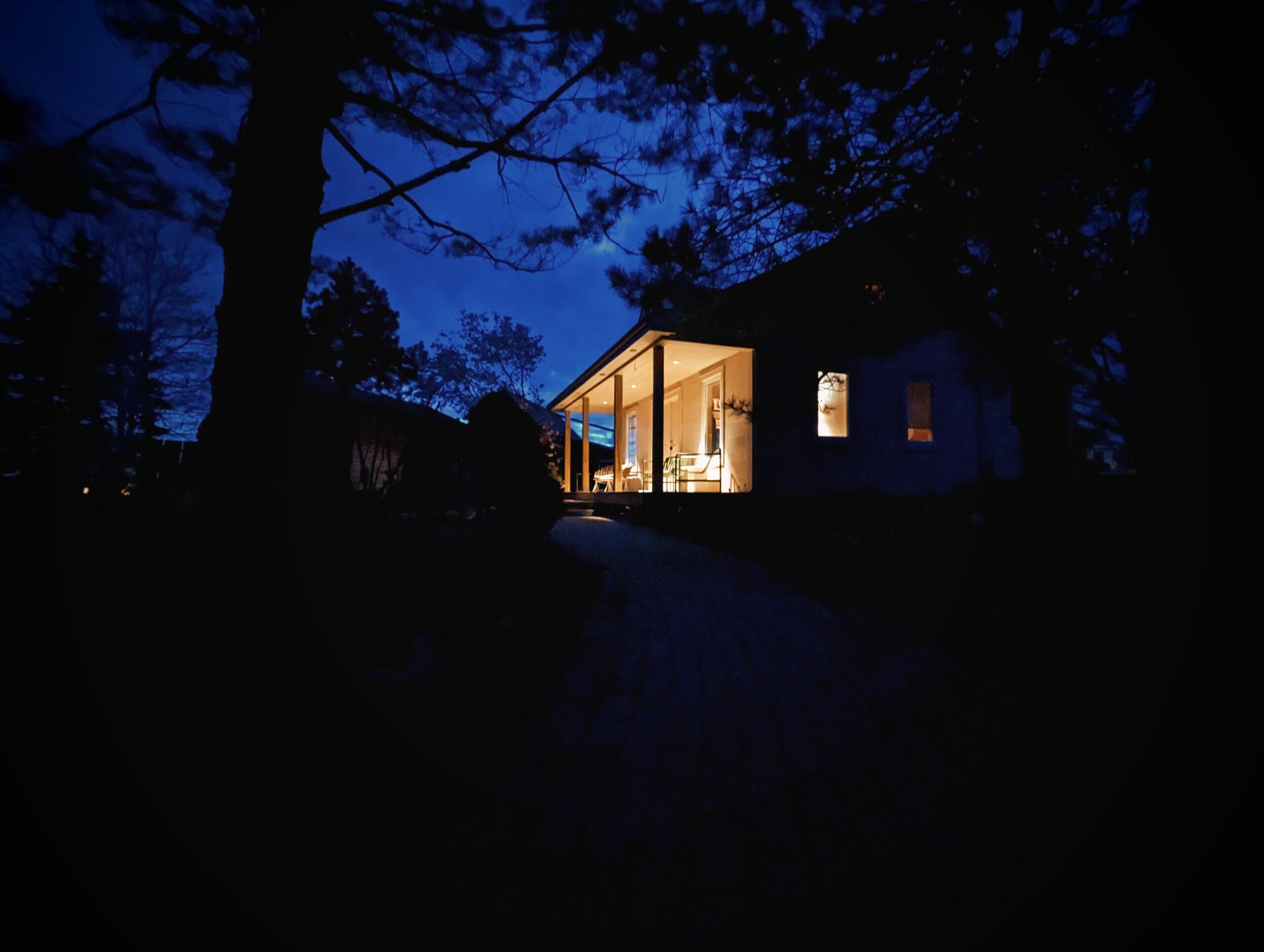 Dark night with lit up cabin front steps