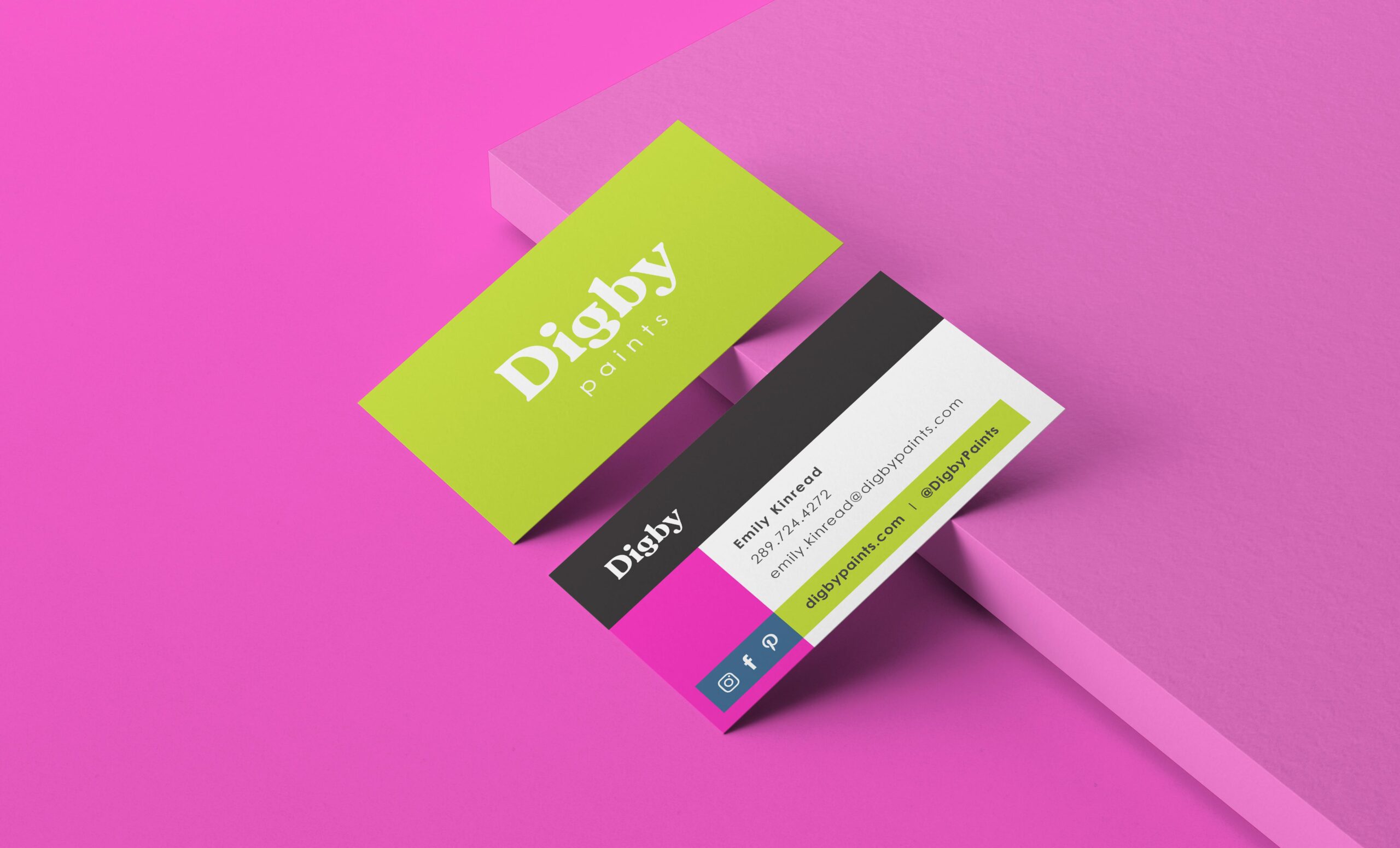 Front and back of Digby business cards against a pink backdrop