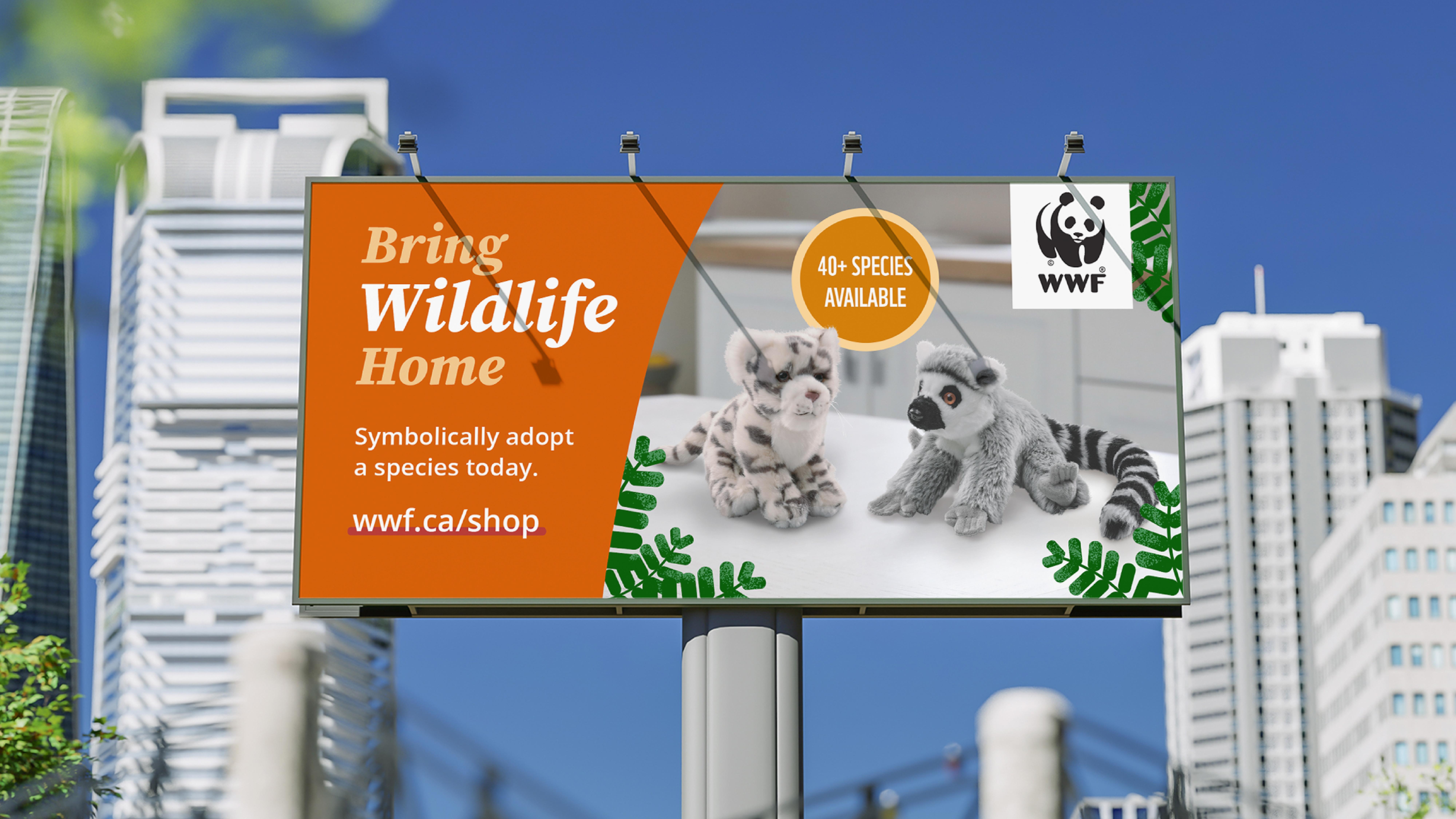 Billboard with WWF ad, showing a snow leopard and lemur plush, with skyscrapers in the background.