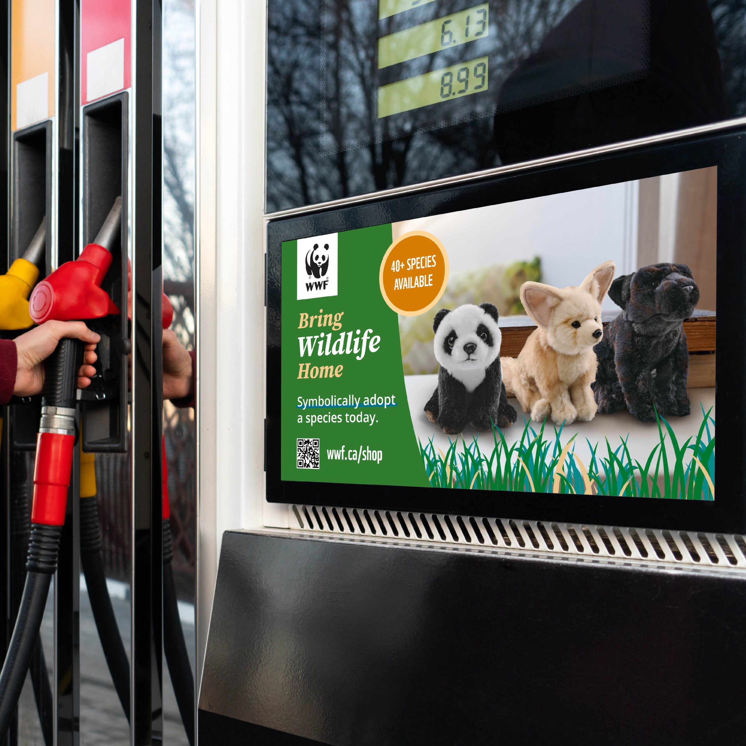 WWF ad showing a panda, fennec fox and panther plush, on a screen near a gas pump.