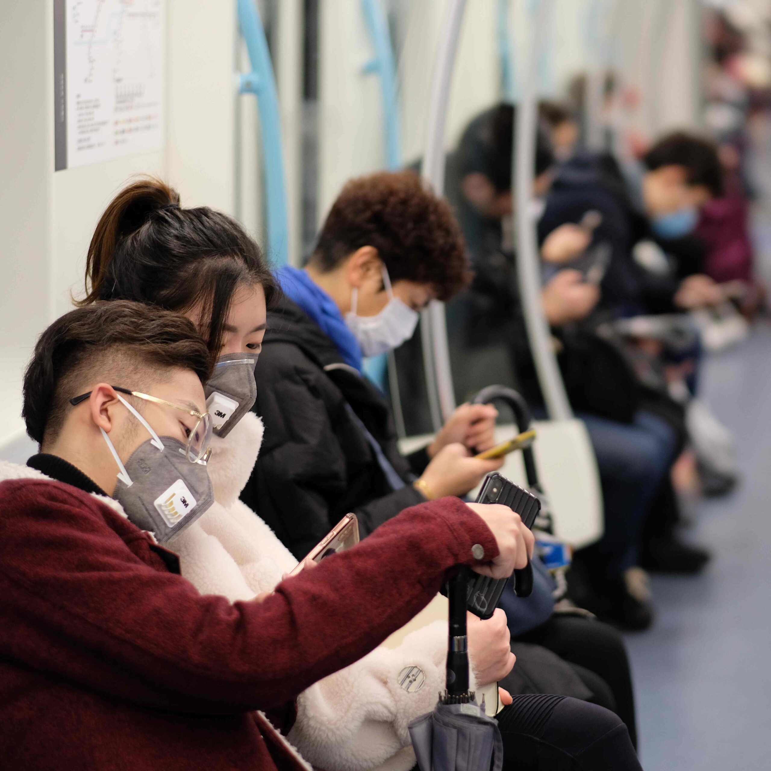 Subway train riders wearing masks