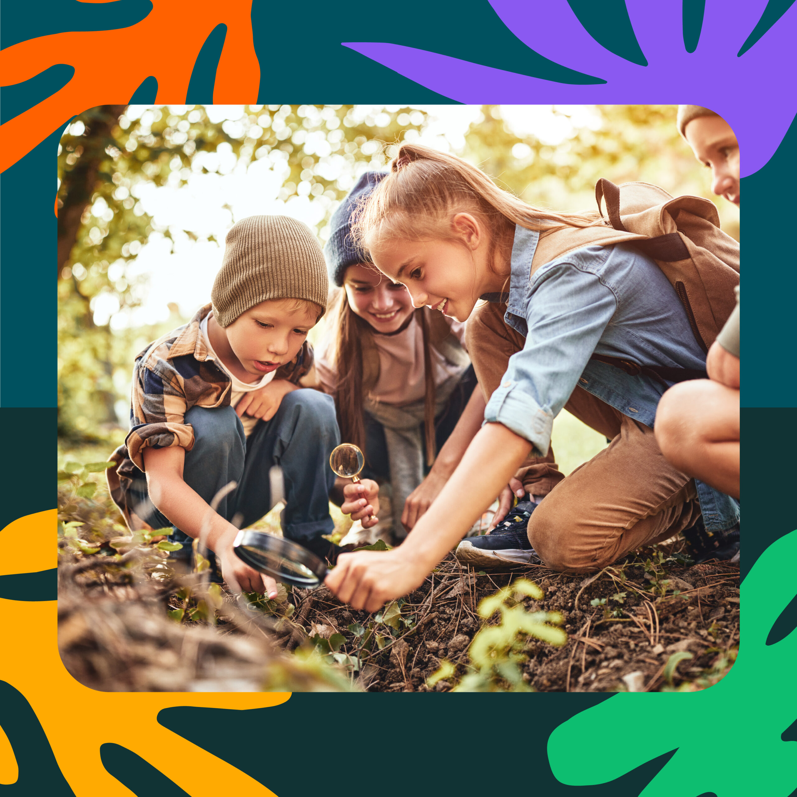 School-aged children in forest peering through a magnifying glass at foliage.