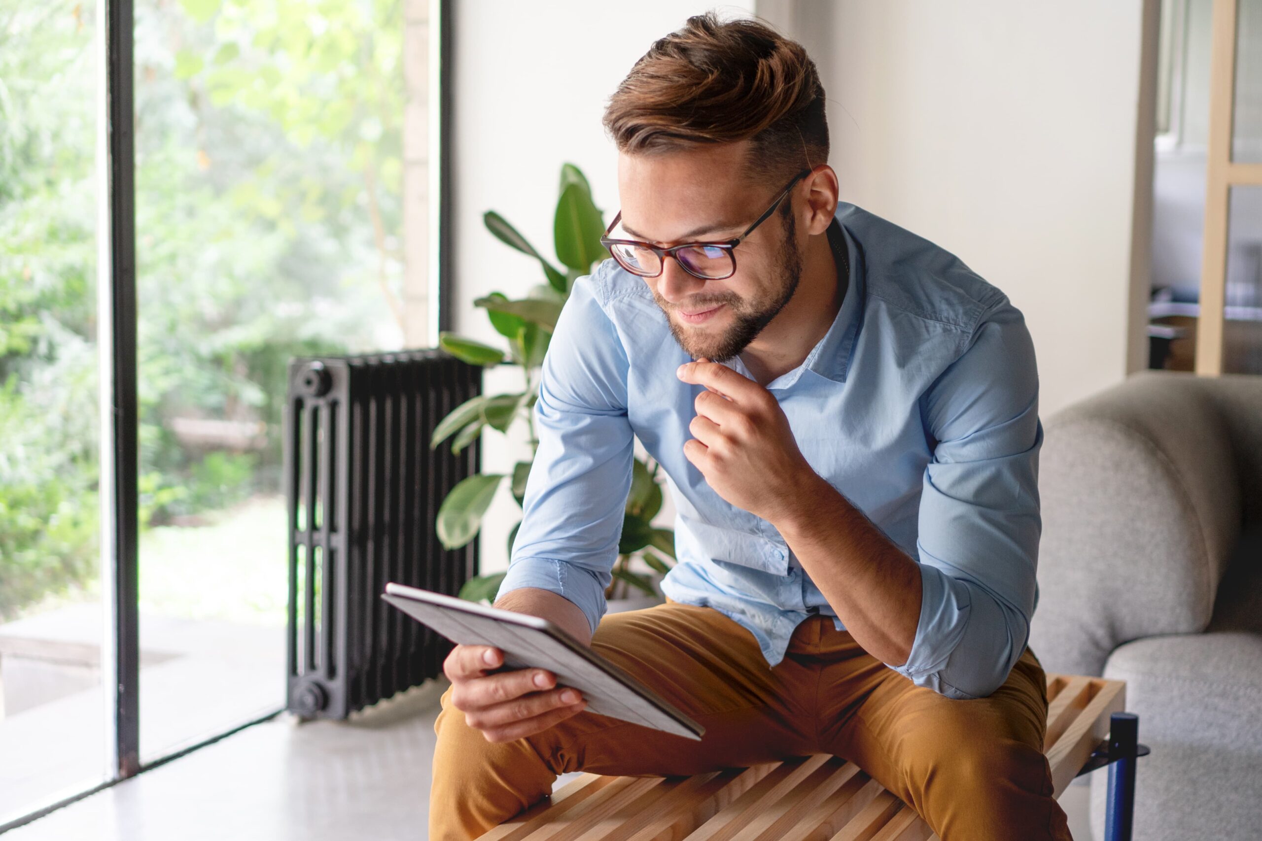 A man scrolling on a tablet device