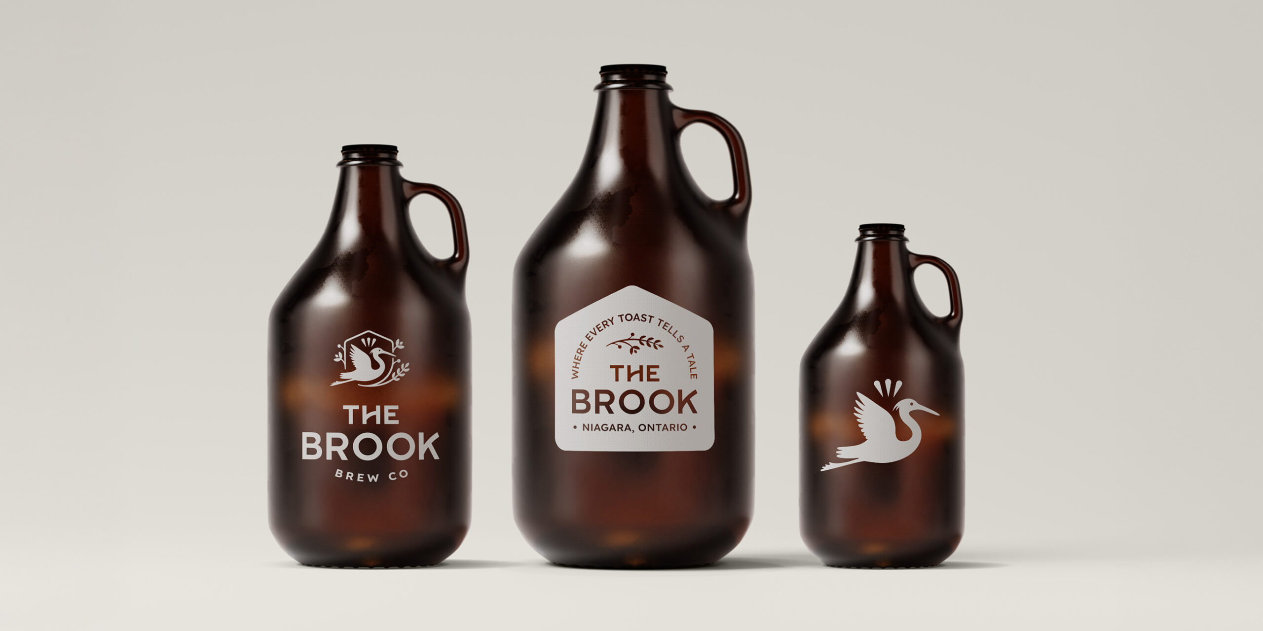 Three brown glass flagons with "The Brook" branding and bird logos, displayed against a plain light background.