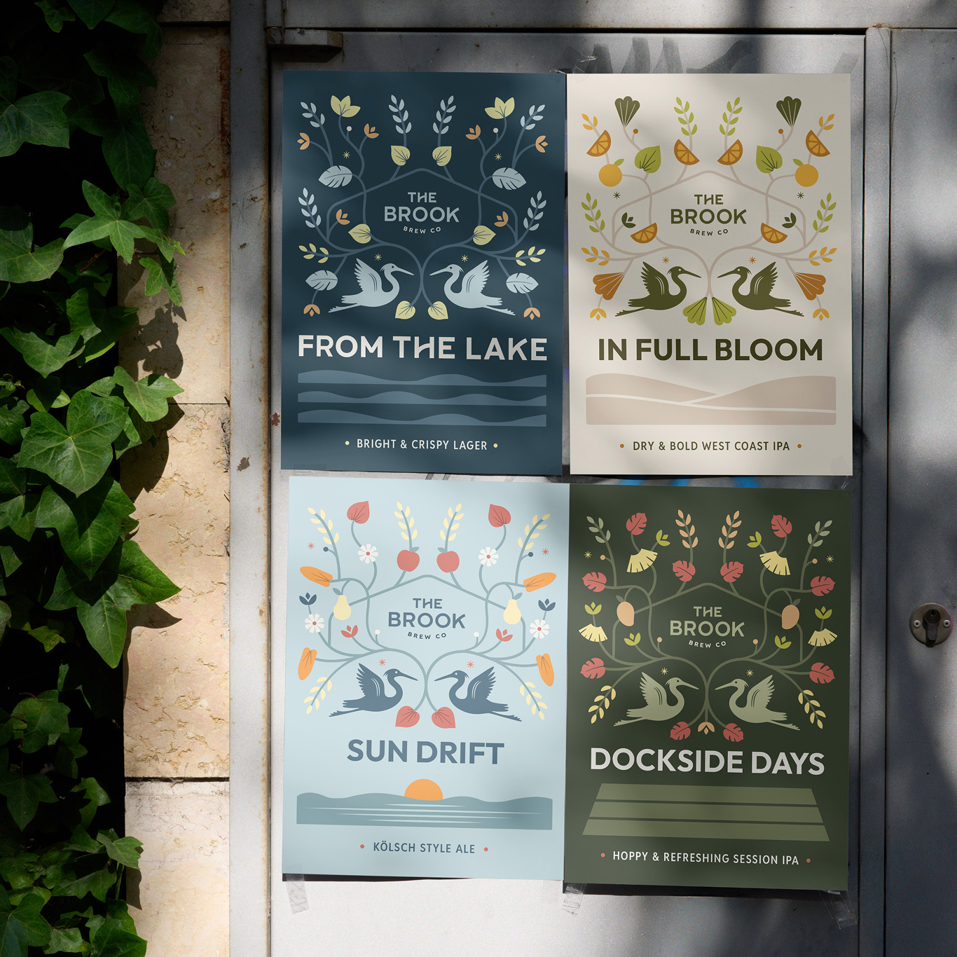 Four illustrated beer posters on a door, each featuring a different variety from The Brook Brewing Company.
