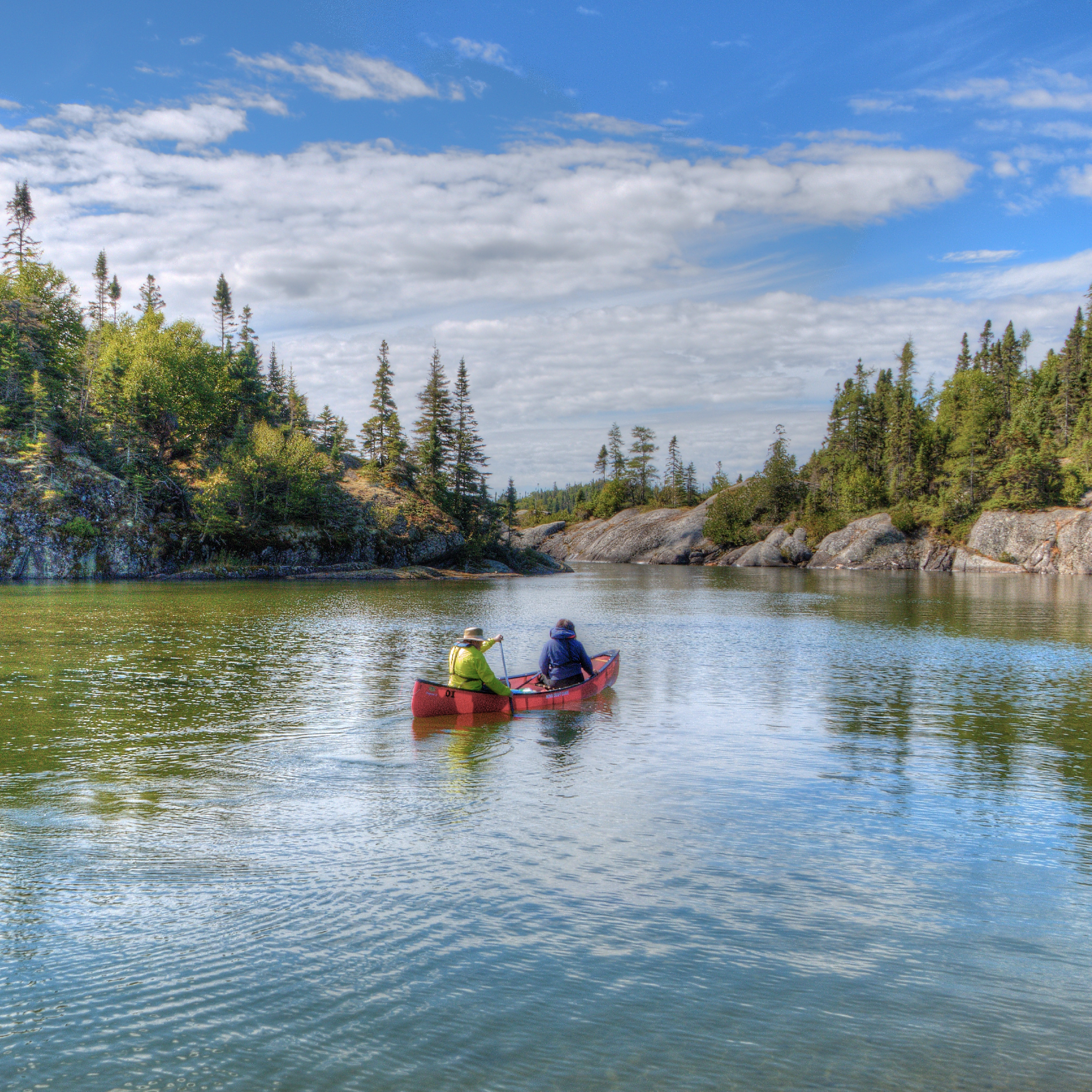 A couple kayaking down a river