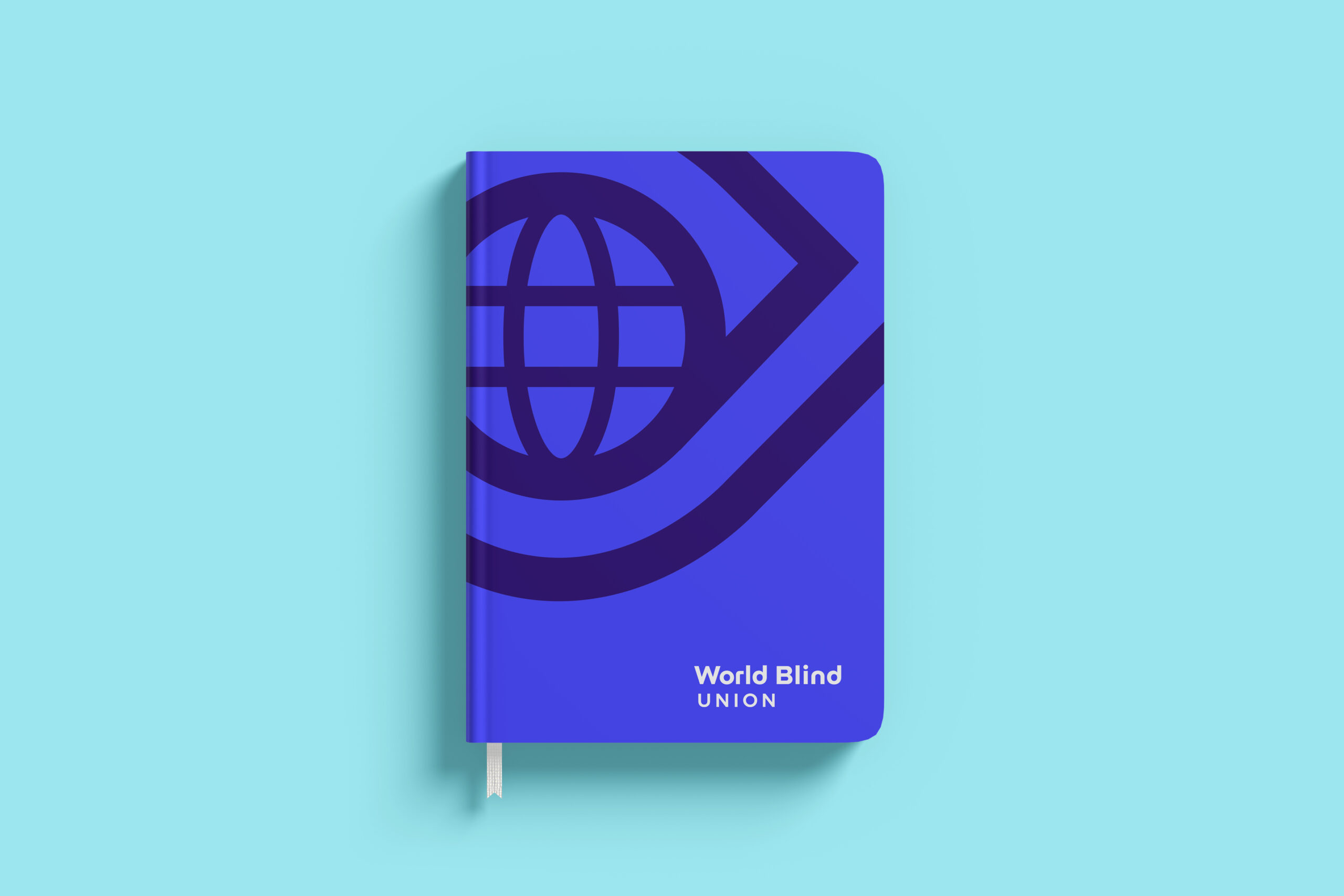 Blue notebook with a globe and eye graphic on the cover, labelled "World Blind Union" on a light blue background.