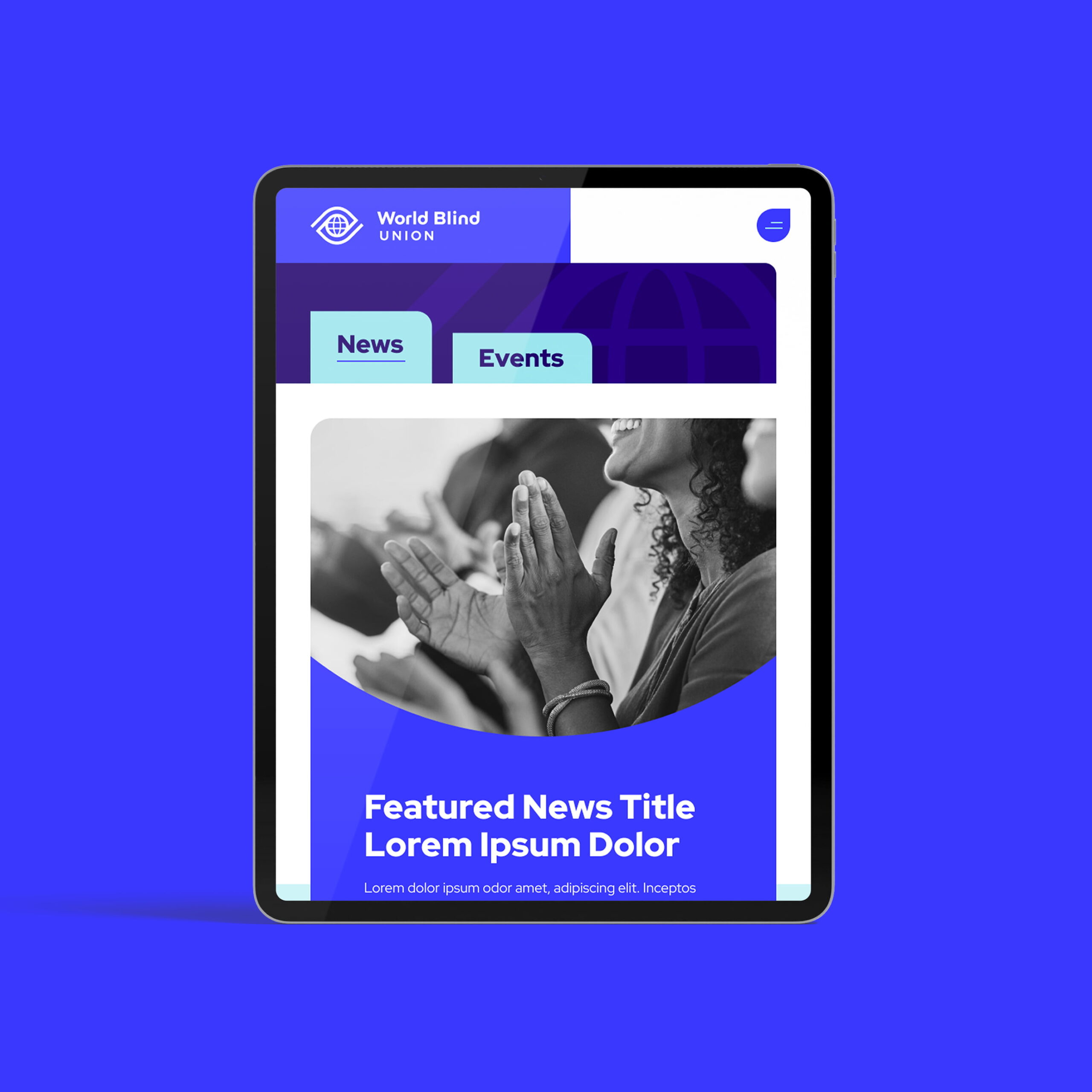 Tablet displaying a website for World Blind Union with news, events tabs, and people applauding in the featured news section.