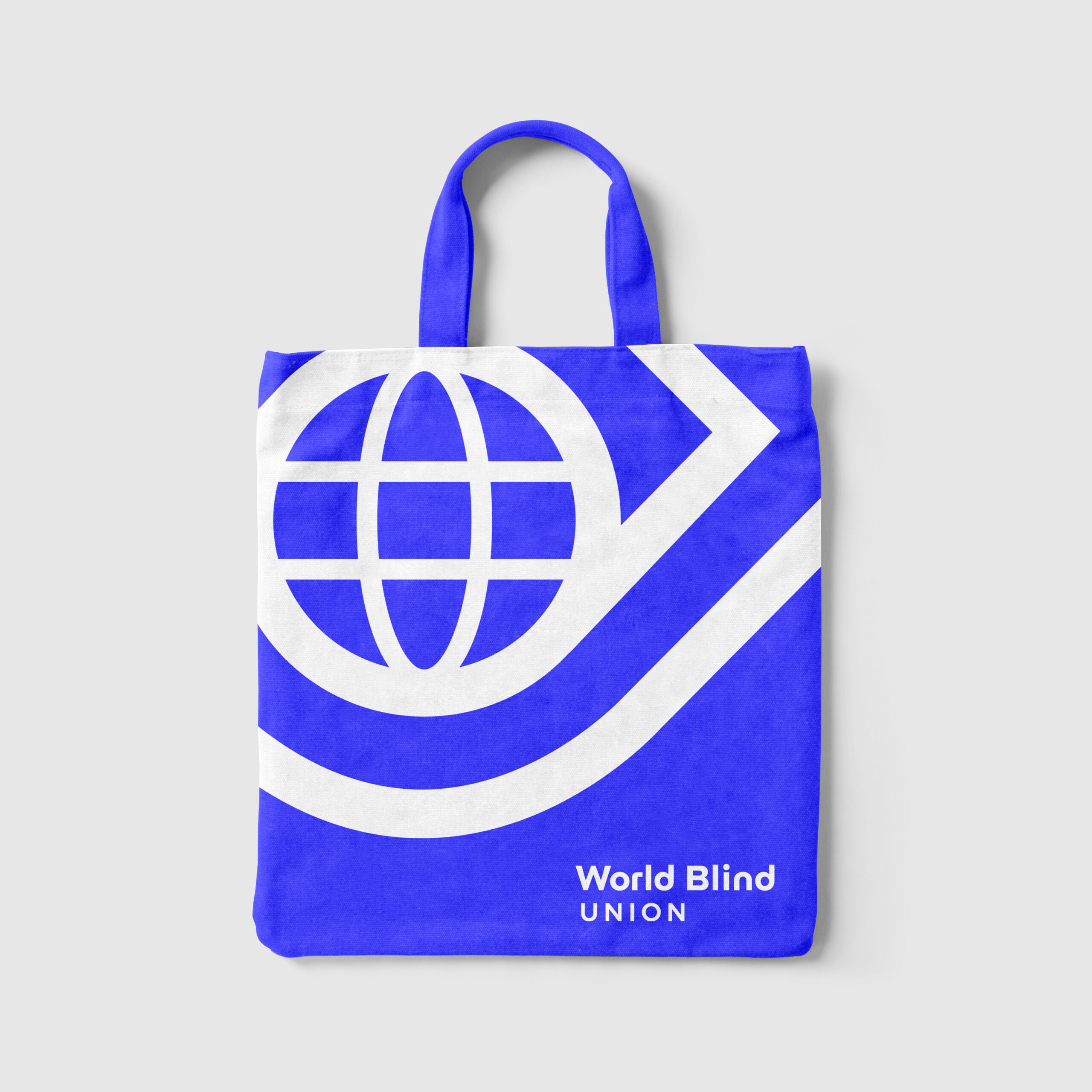 Blue tote bag featuring the World Blind Union logo and text on a plain light grey background.